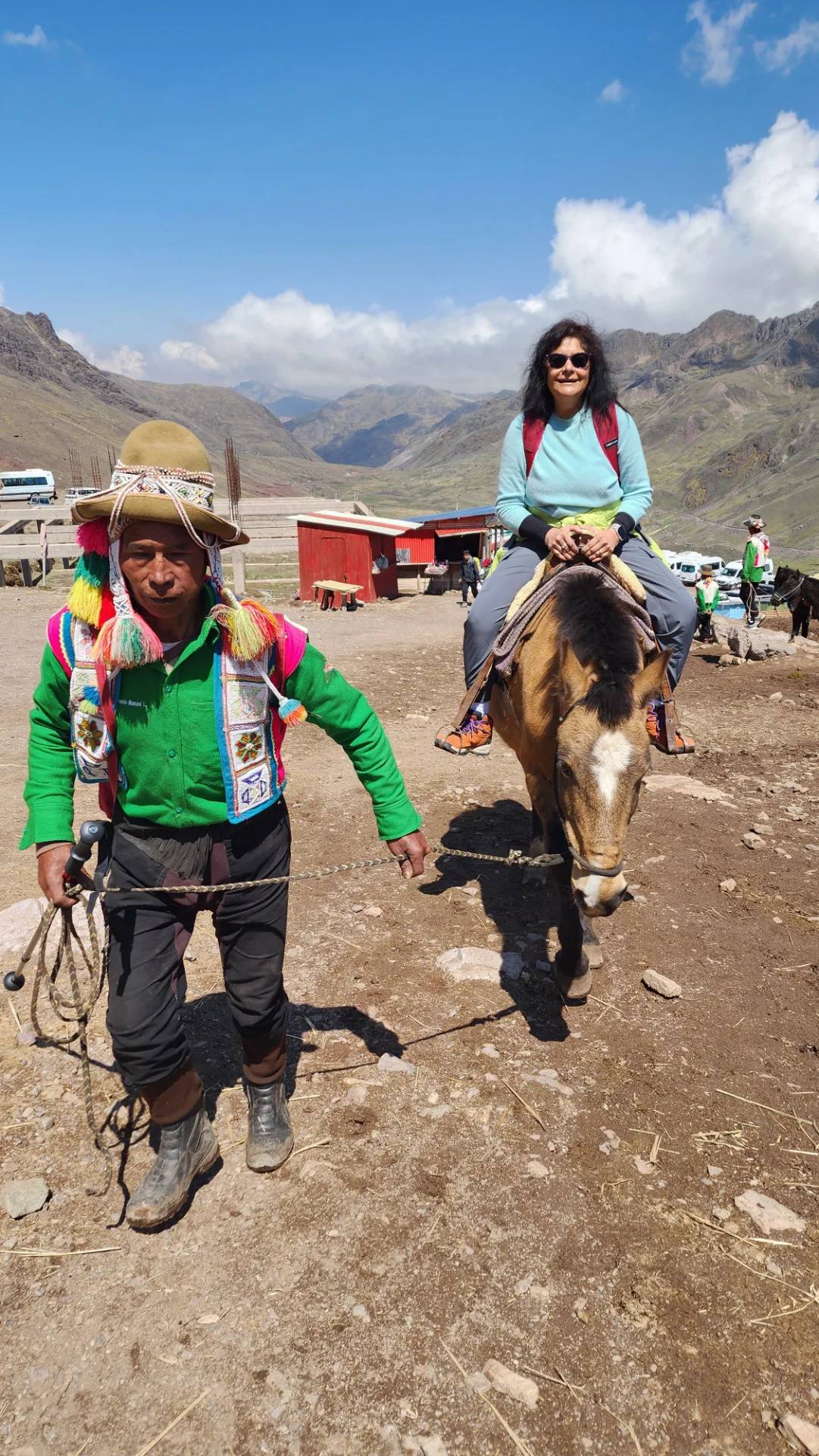 Trekkers reaching the Rainbow Mountain summit viewpoint in the Andes