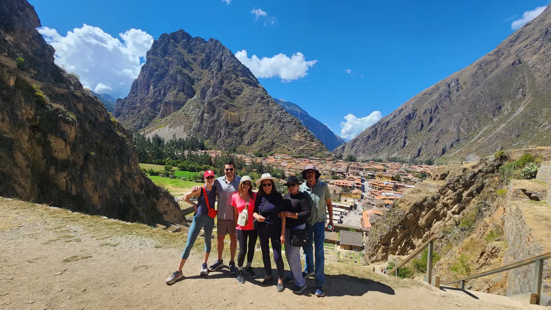 The Inca terraces of Pisac curve along the mountainside above the valley.